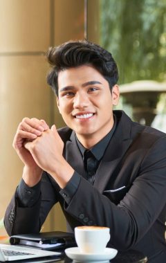 cheerful-asian-businessman-in-cafe-2021-08-27-09-53-58-utc-Custom-e1643051444112.jpg