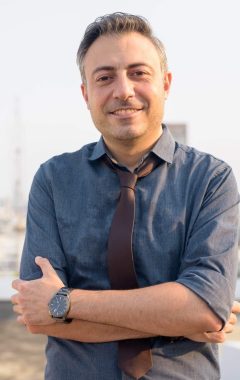 happy-mature-handsome-businessman-smiling-with-arm-2021-08-27-18-01-49-utc-Custom-e1643051599503.jpg