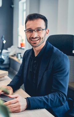 portrait-of-a-smiling-businessman-in-his-office-2021-09-03-15-39-47-utc-Custom-e1643050396924.jpg